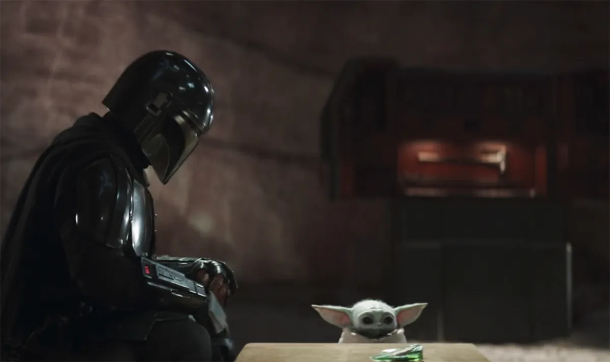 Din Djarin and Grogu sitting at a table in The Mandalorian