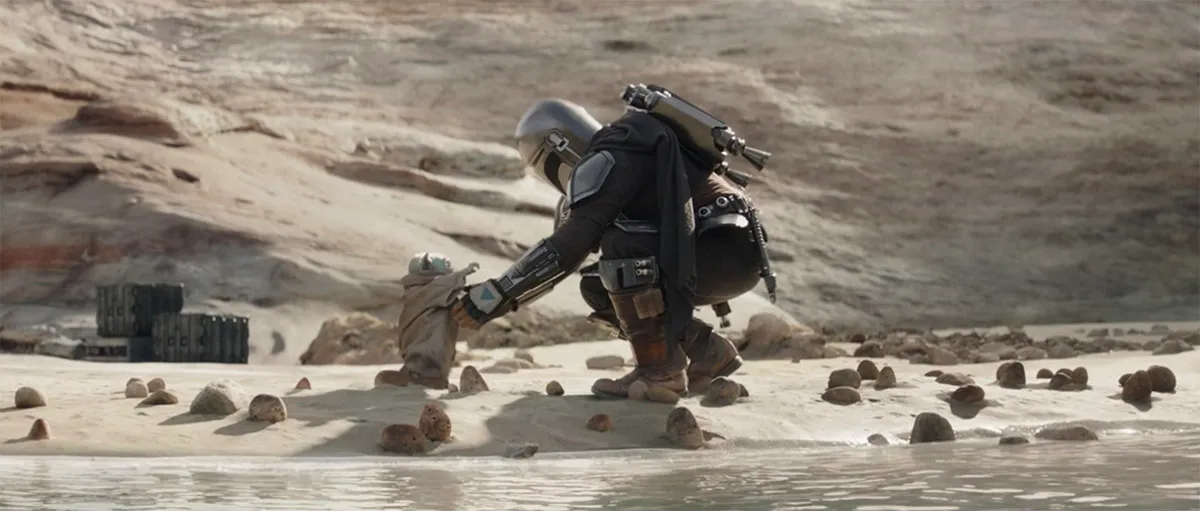 Grogu running to Din's arms in the Mandalorian