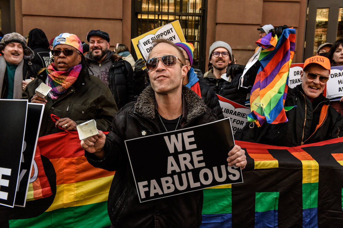 Protesters supporting Drag Queen story hour hold signs, including one reading "We are fabulous"