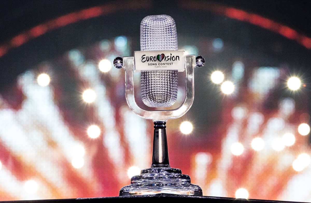 The Eurovision trophy, shaped like a microphone, with a fireworks background.