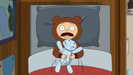 Animated character Moon, a young boy, seen from above in his bed, clutching a stuffed animal, yelling