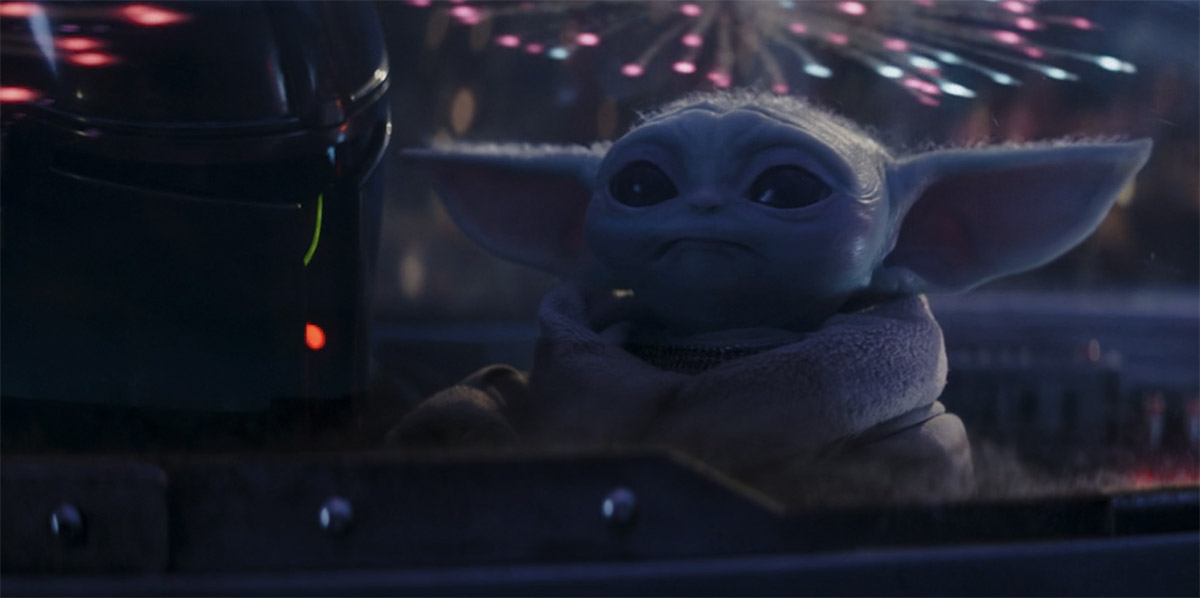 Grogu watching fireworks happen on Tatooine with his dad like a kid on the fourth of july in The Mandalorian