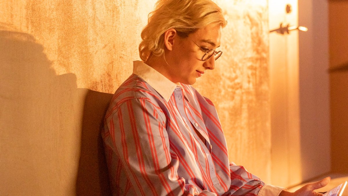 Ian (Mason Alexander Park) sits against a wall, looking down.