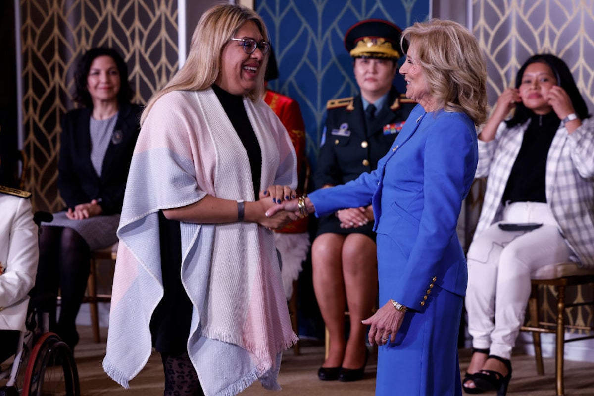 Jill Biden shakes a woman's hand during a ceremony.