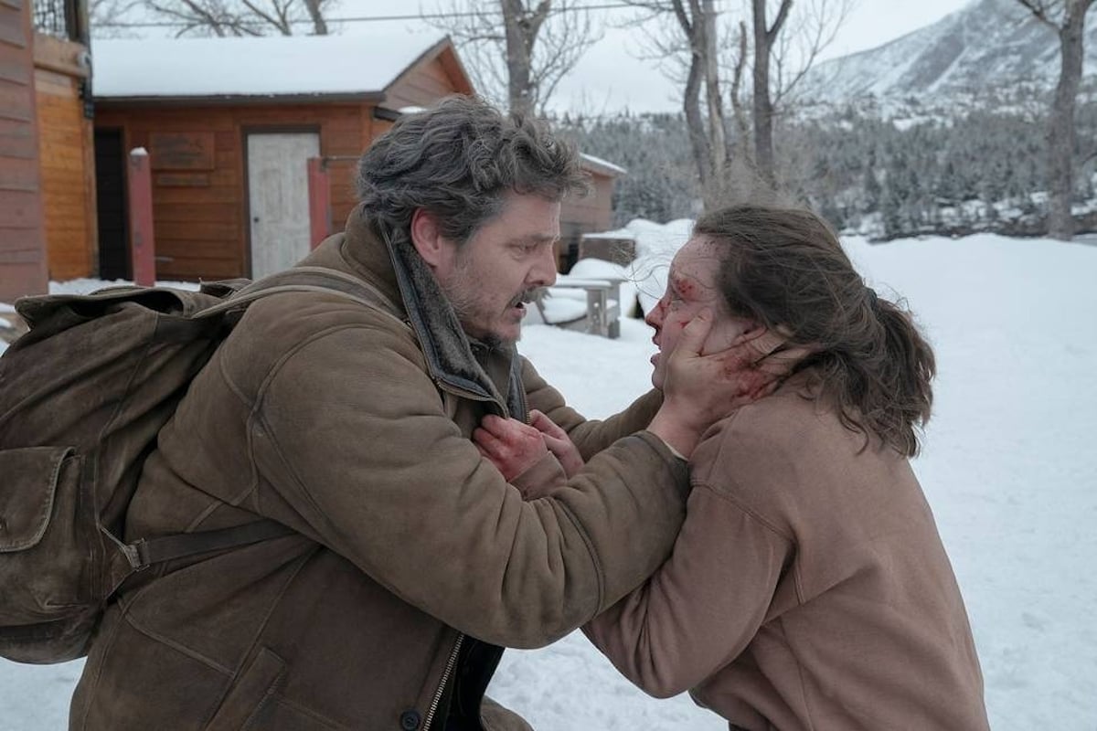 Pedro Pascal as Joel grabbing Bella Ramsey as Ellie's face in 'The Last of Us' episode 8.