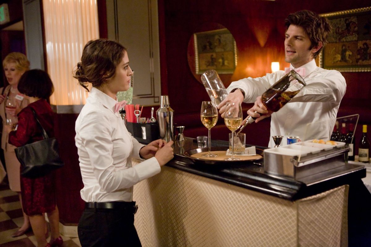 Lizzy Caplan as Casey Klein and Adam Scott as Henry Pollard talking in Party Down