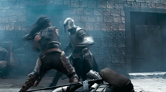 GIF of Michelle Rodriguez as Holga in 'Dungeons & Dragons: Honor Among Thieves.' Holga is kicking the crap out of three or four guards in armor with lots of flips and body slams. 