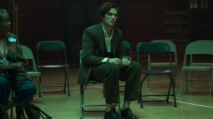 Nicholas Hoult sitting in a chair as Robert in Renfield
