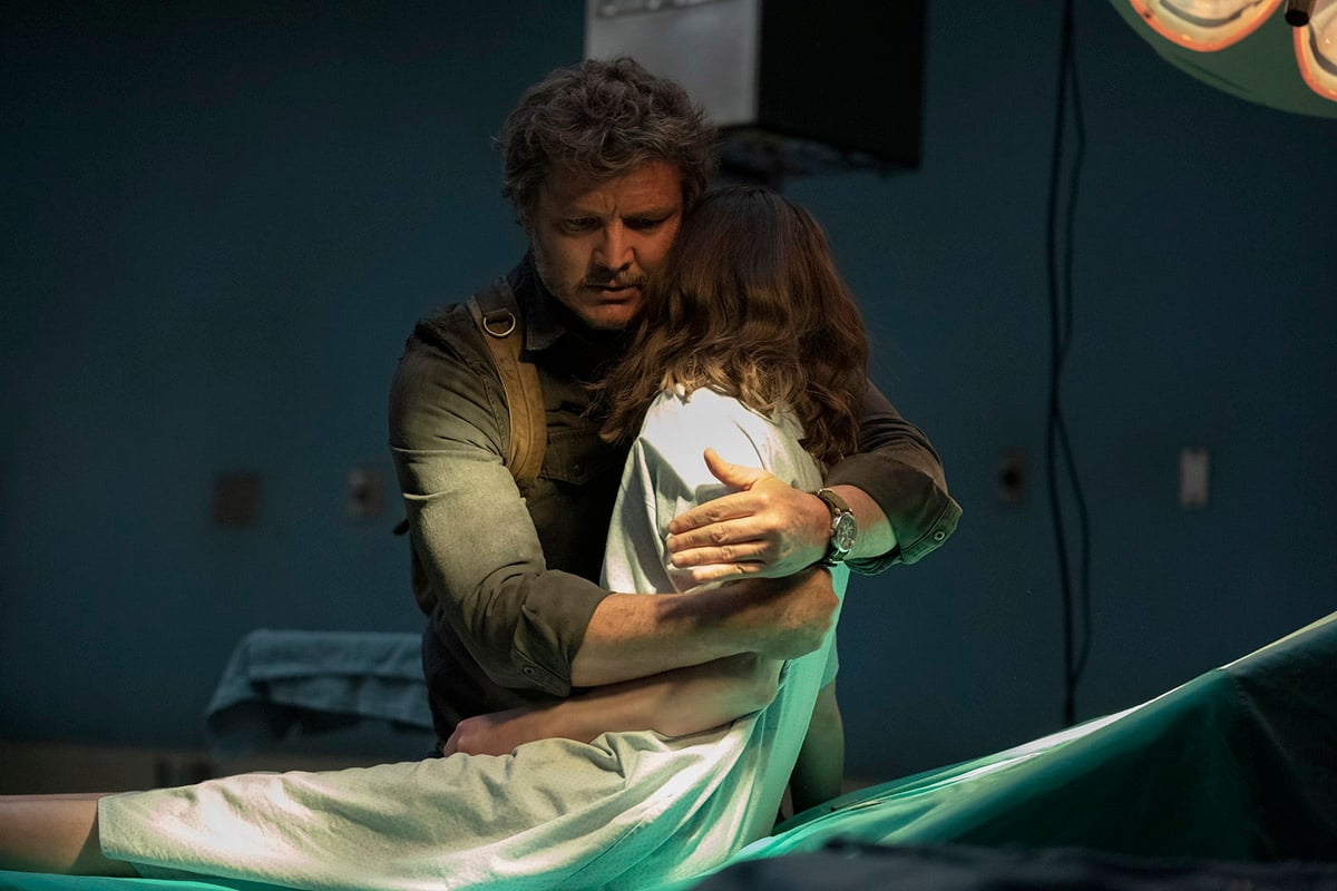 Pedro Pascal as Joel Miller hugging Ellie (Bella Ramsey) in the hospital in The Last of Us