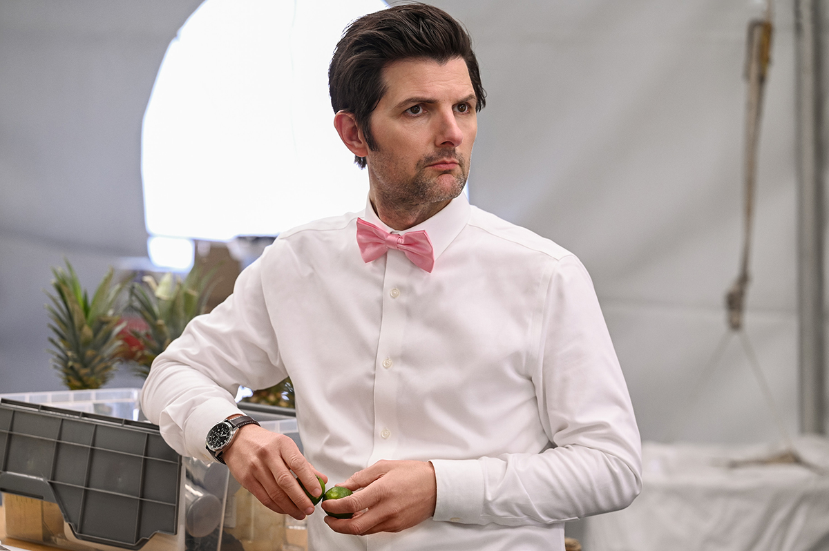 Adam Scott as Henry Pollard leaning on a bar in Party Down