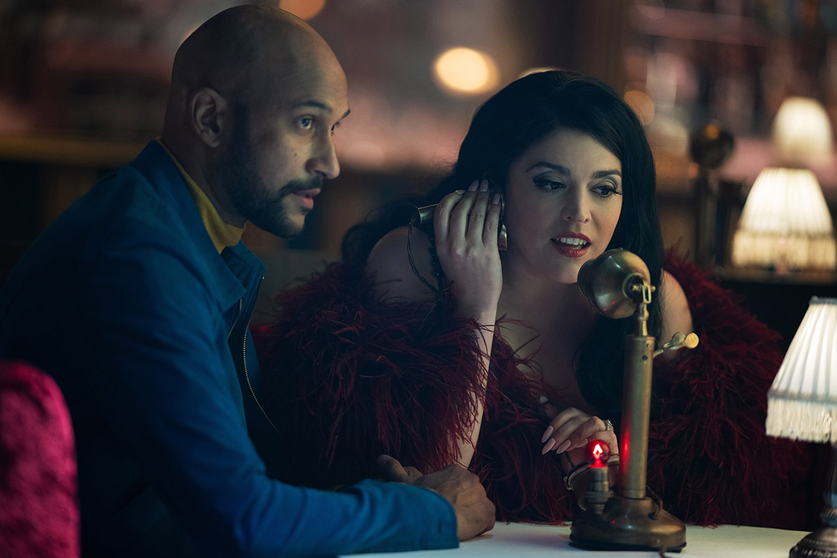 Cecily Strong and Keegan Michael Key in Schmigadoon season 2 with a microphone