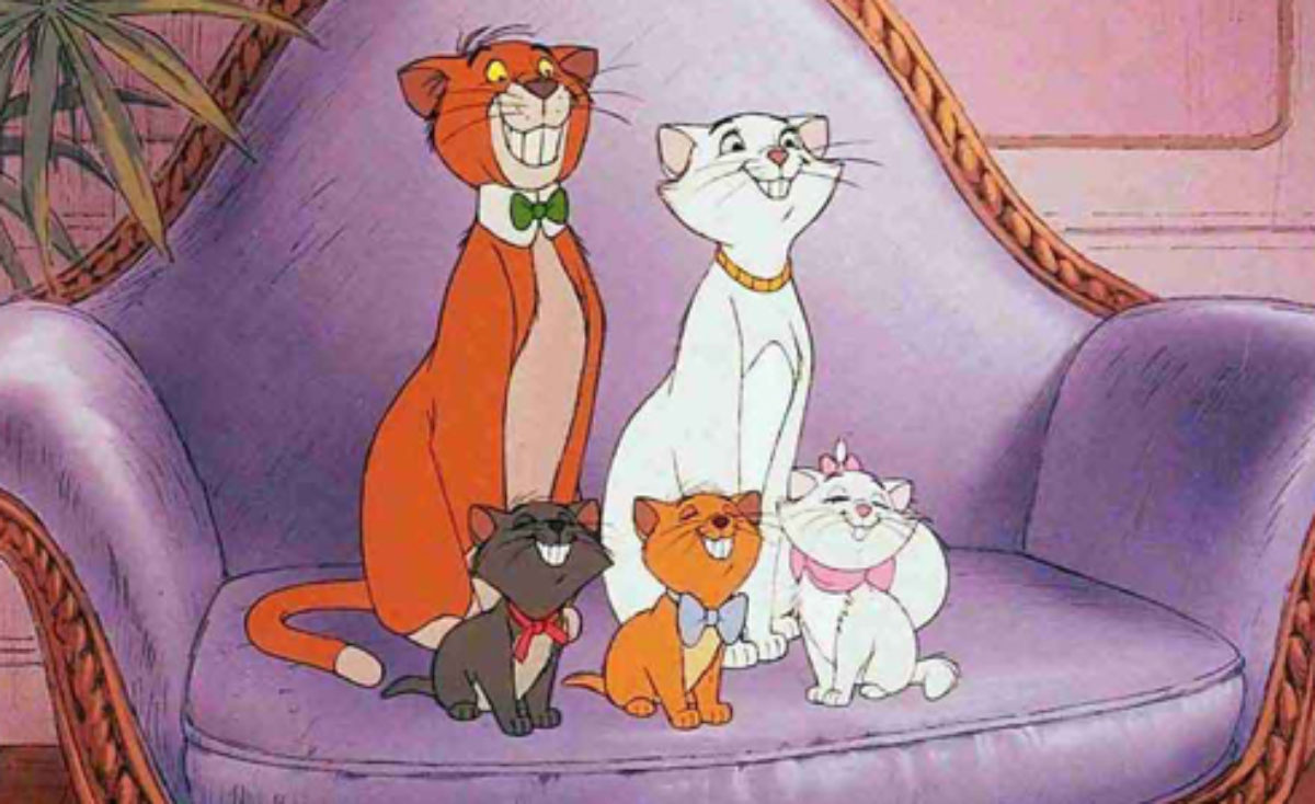 Tom, Duchess, and the kittens smile on the couch in Aristocats.