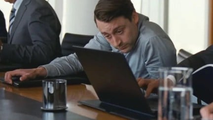 Roman Roy looks anxiously at a laptop in a scene from Succession.