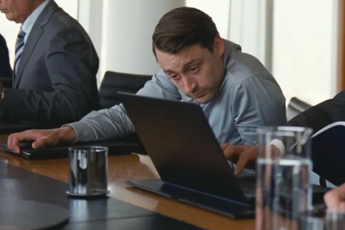 Roman Roy looks anxiously at a laptop in a scene from Succession.