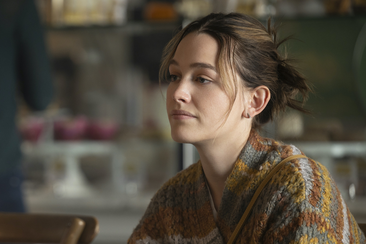 Victoria Pedretti stares wistfully in a scene from You.