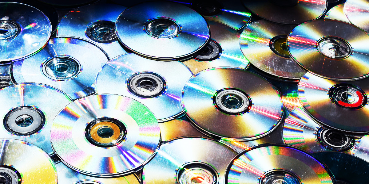 A pile of upside down DVD discs