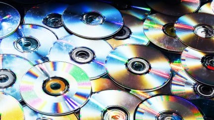 A pile of upside down DVD discs