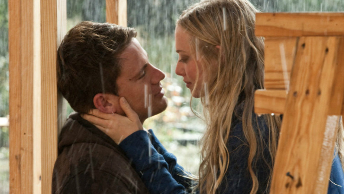 Savannah and John gaze into each other's eyes while in the rain