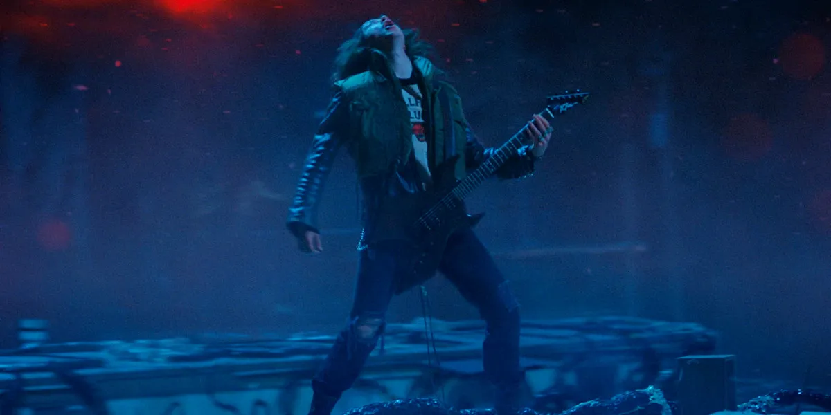 Joseph Quinn as Eddie Munson in Stranger Things season 4 in the Upside Down playing guitar