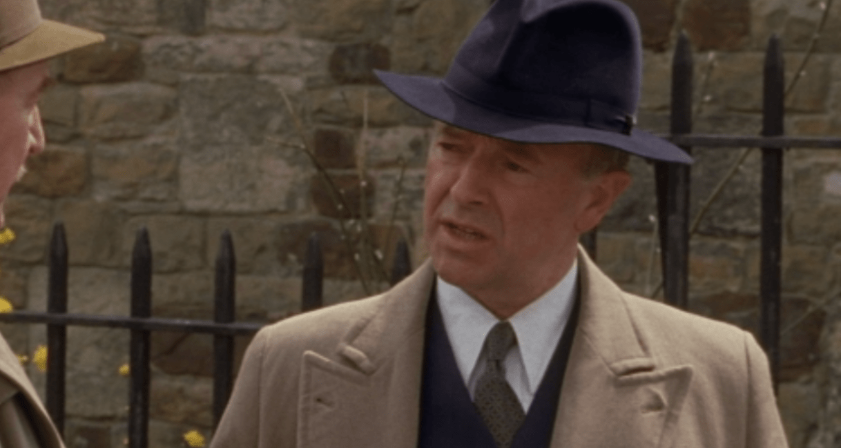 A close up of DCS Christopher Foyle in a trench coat 