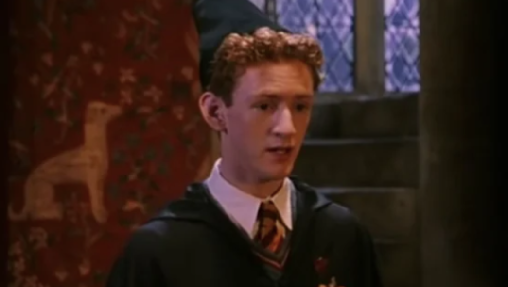 Percy Weasley wears a tall wizard hat