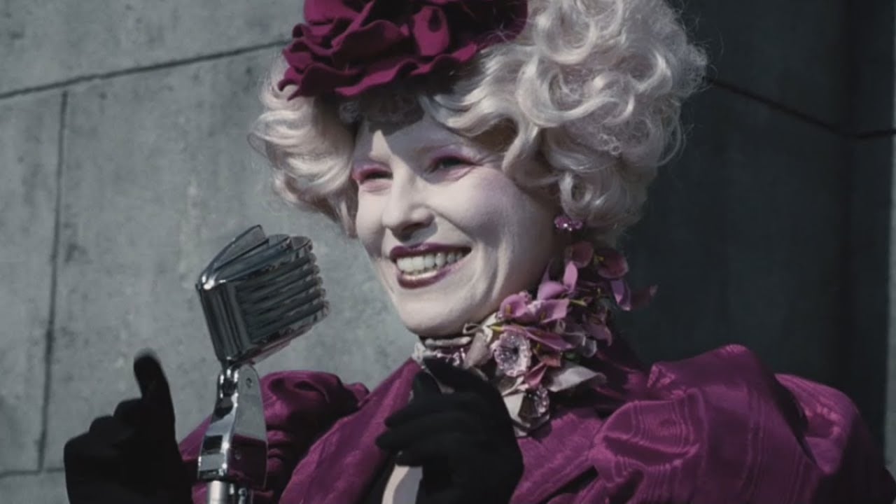 Effie Trinket, as she was played by Elizabeth Banks, in the first Hunger Games movie
