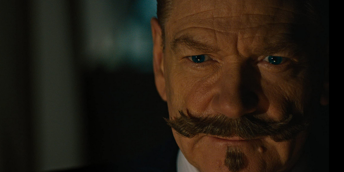 A close-up of Kenneth Branagh's face as Hercule Poirot in A Haunting in Venice