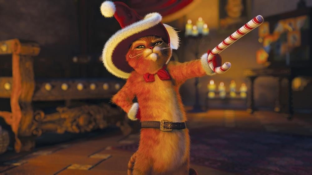 Puss in Boots wears a santa hat and swings a candy cane like a sword.