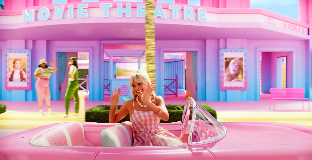 Margot Robbie as Barbie driving her pink convertible in Barbie