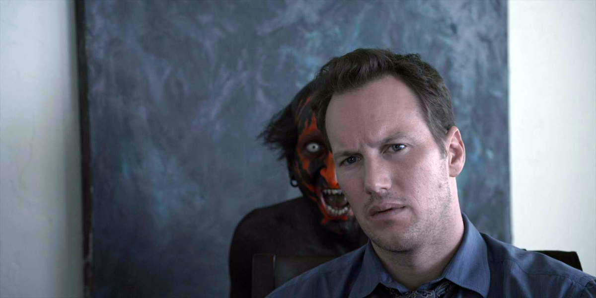 A red-and-black demon appears behind Patrick Wilson in 'Insidious'