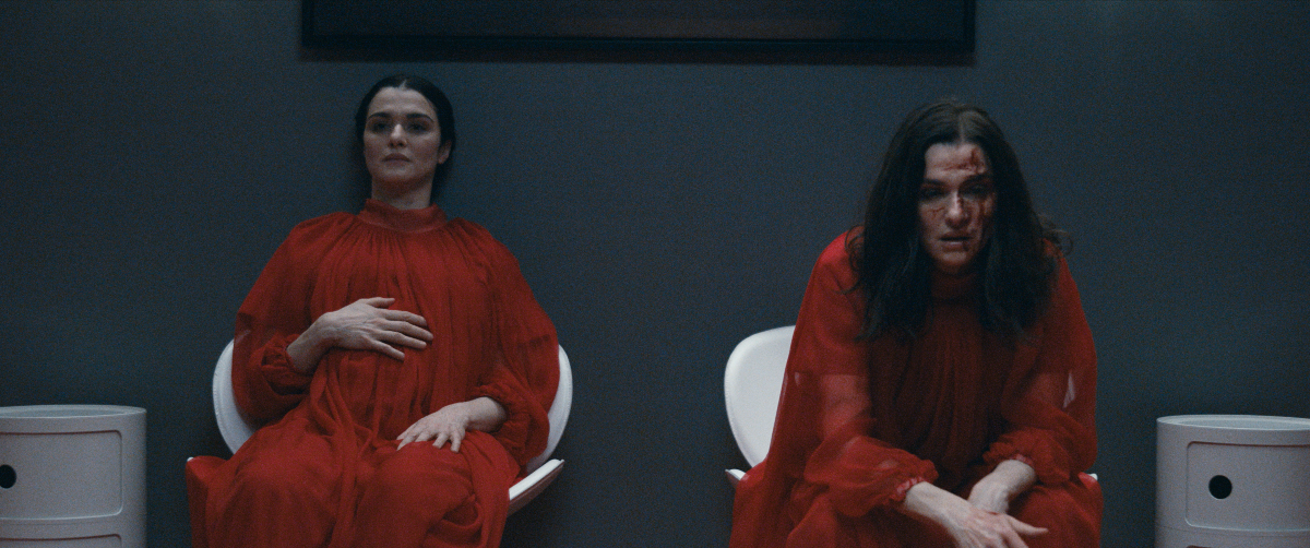 A pregnant Beverly (Rachel Weisz) reclines, exhausted next to her sister Elliot (also Weisz), bloodied from their work as gynecologists in 'Dead Ringers'