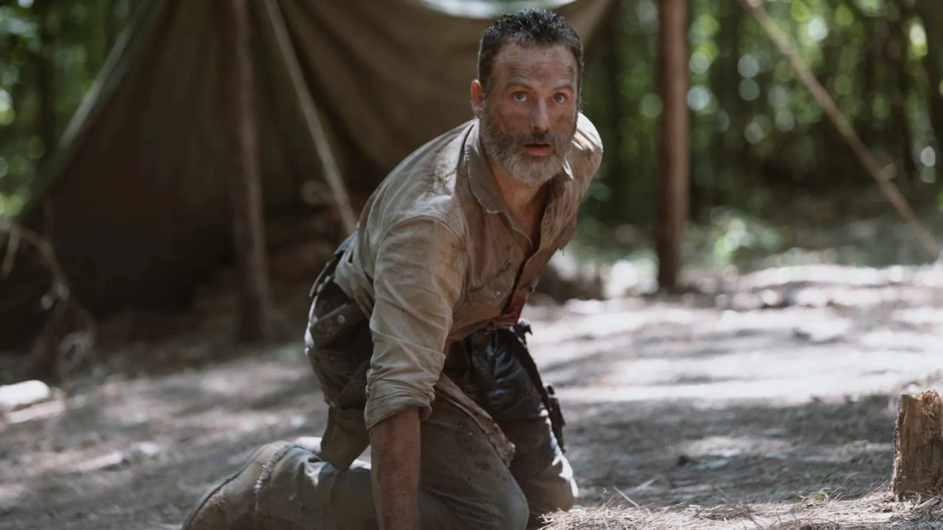 An injured Rick Grimes struggling to get away from walkers in The Walking Dead season 9