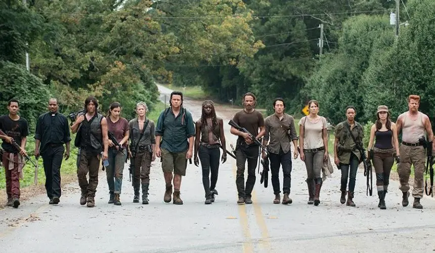 Team family (minus Carl and Judith) walking down the road together in The Walking Dead season 5