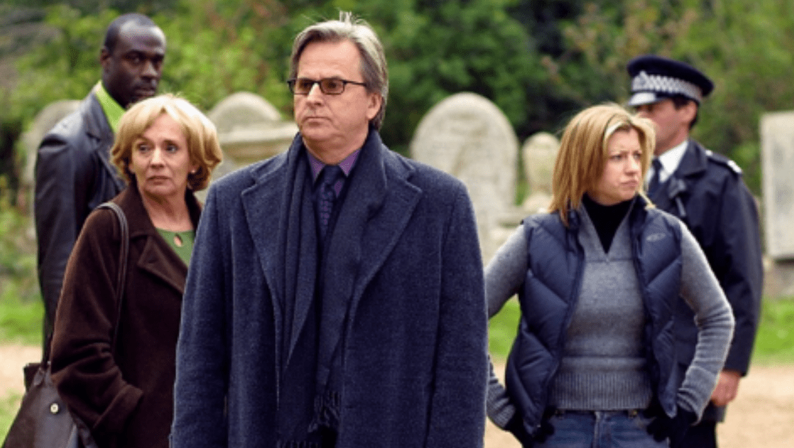 The cast of 'Waking the Dead' stand in a graveyard