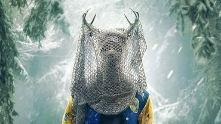 The Antler Queen from Yellowjackts: a figure wearing antlers, a varsity jacket, and a soccer net obscuring their face stands against a snowy background.