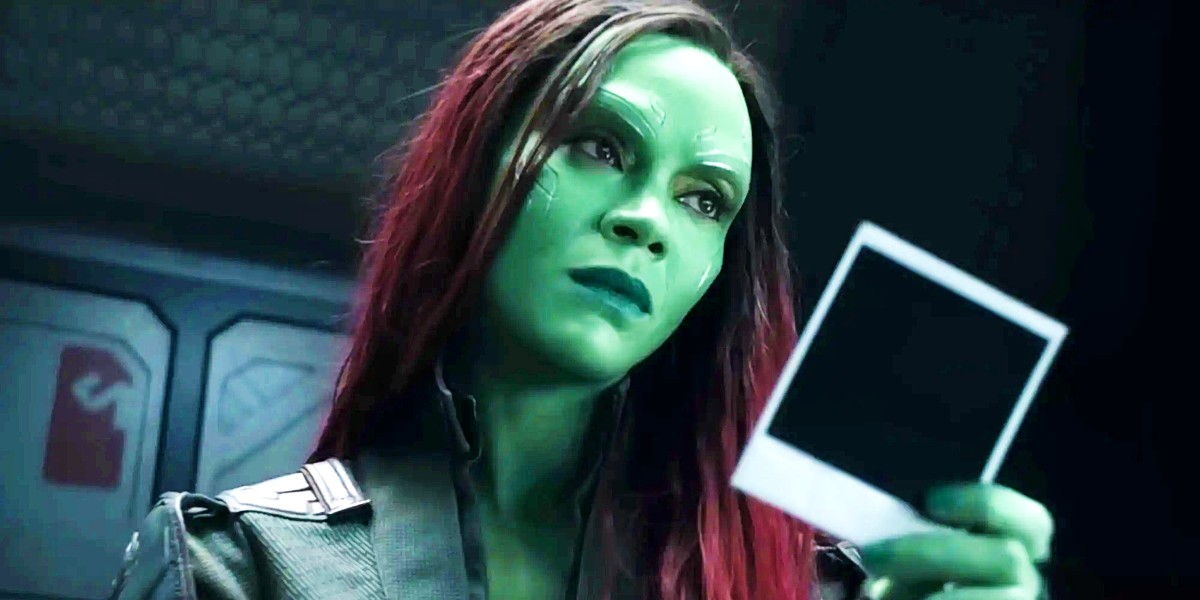 Zoe Saldana as Gamora holding a polaroid in Guardians of the Galaxy Vol. 3