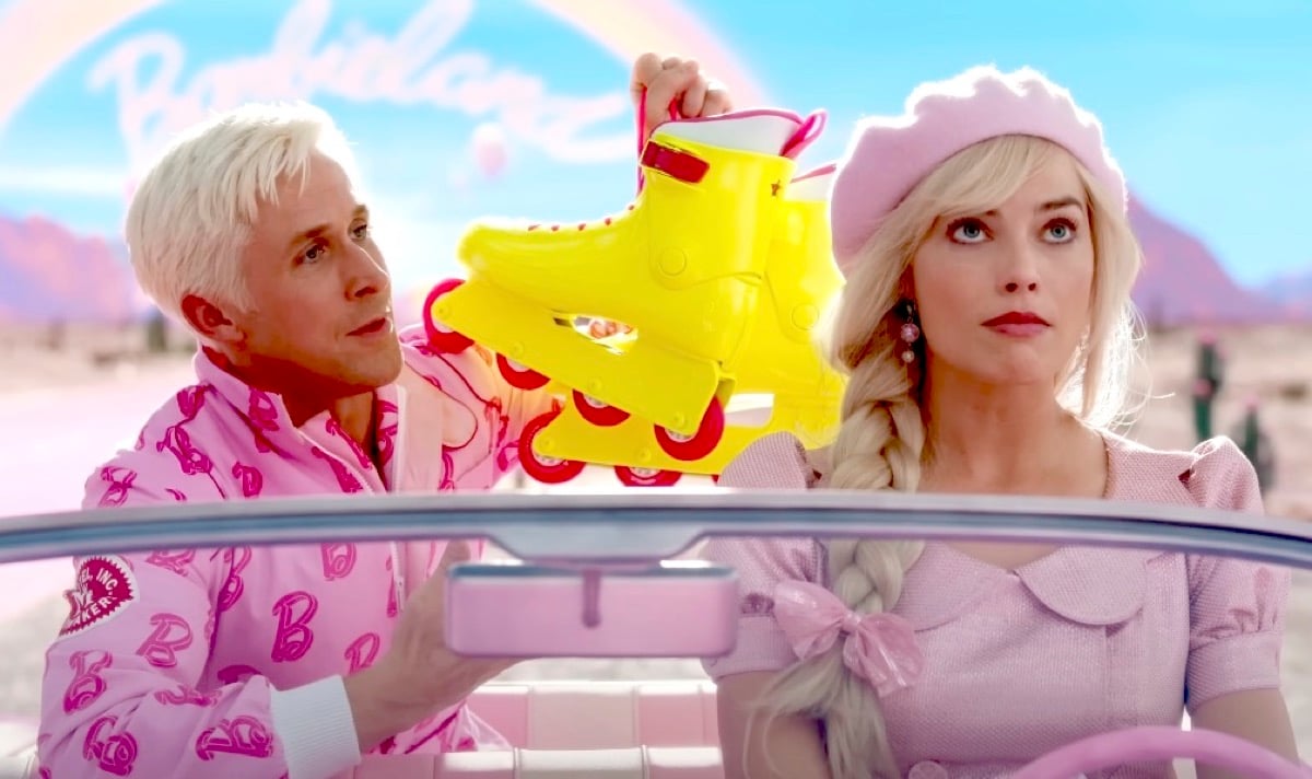 Ken shows an exhasperated Barbie his rollerblades from the back seat of her car in Greta Gerwig's Barbie movie trailer.