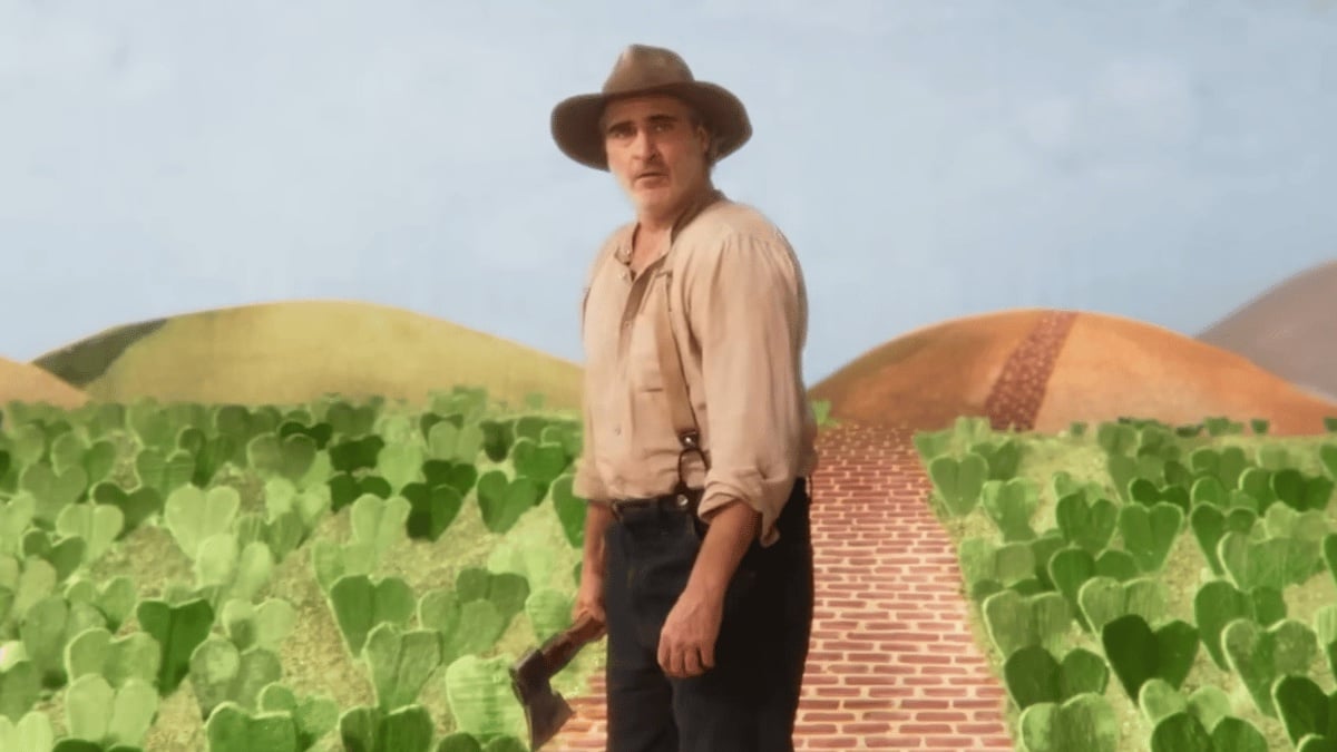 Beau stands against a painted backdrop showing plants and a brick road going off into hills. Beau is wearing an 1800's-era hat and suspenders, and holding an ax.