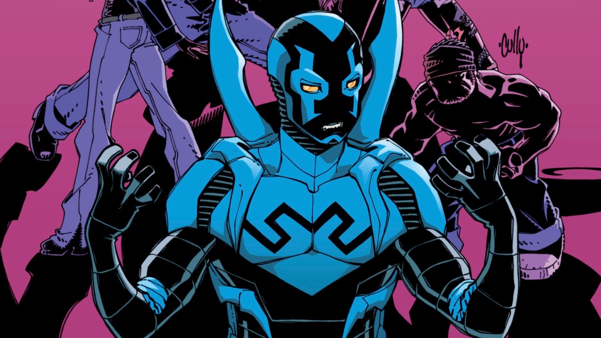 Image from a cover of an issue of the 'Blue Beetle' comic from DC Comics. It's Blue Beetle in his blue super suit, which is a light blue and black. He's looking at his hands as he holds them up, as if some power is going to erupt from them. Behind him are the dark figures of other characters against a pink background. 