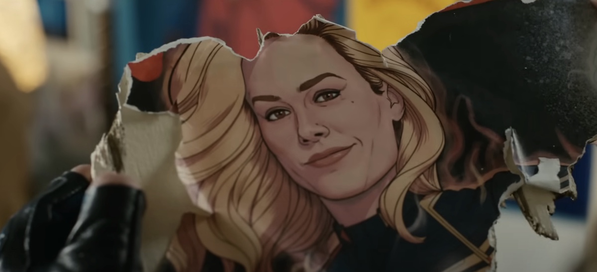 A torn poster showing an artist's rendering of Brie Larson smiling as Captain Marvel.