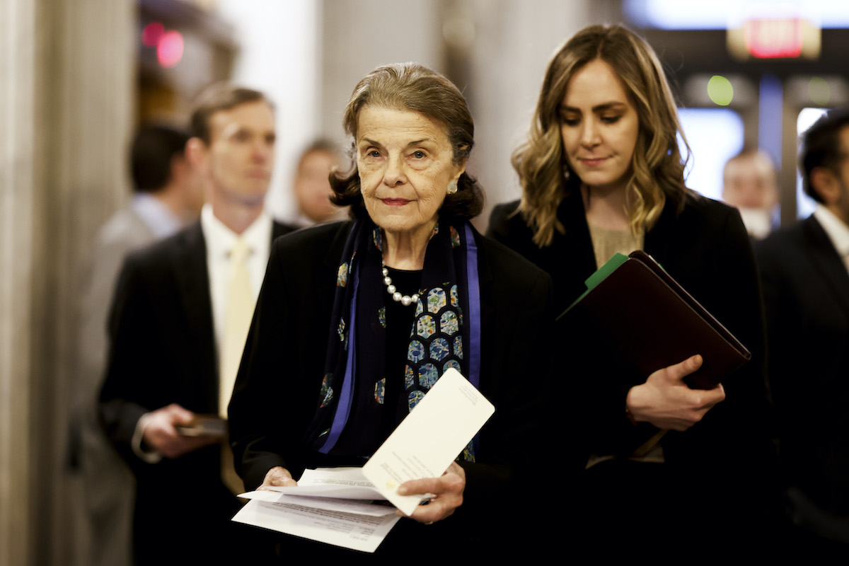 Senator Dianne Feinstein walks through the halls of the Capitol Building.