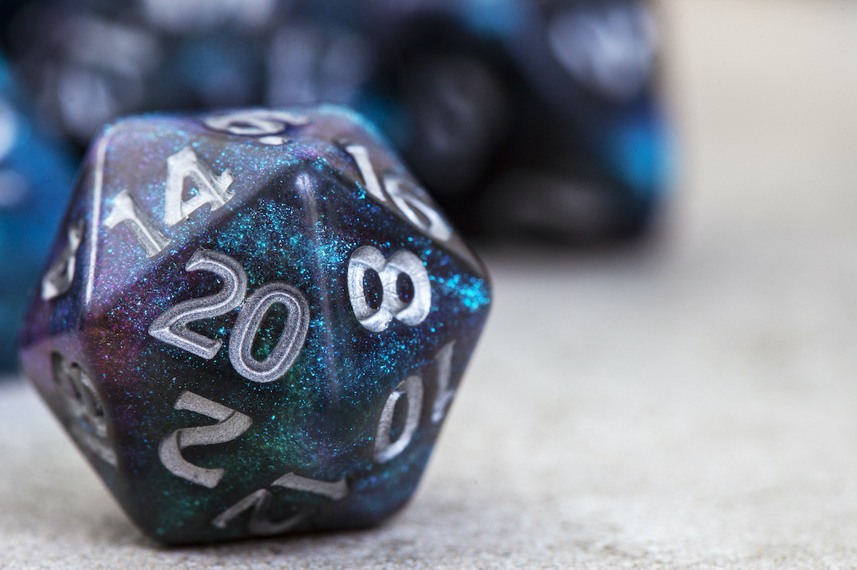 Close-up of a blue glittery D20 die.