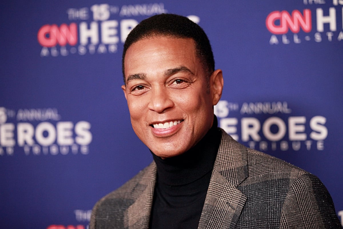 Don Lemon smiles at the camera at an event red carpet, the backdrop behind him reading "CNN Heroes"