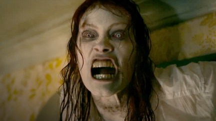 Ellie growls, with clammy white skin and yellow eyes, in Evil Dead Rise.