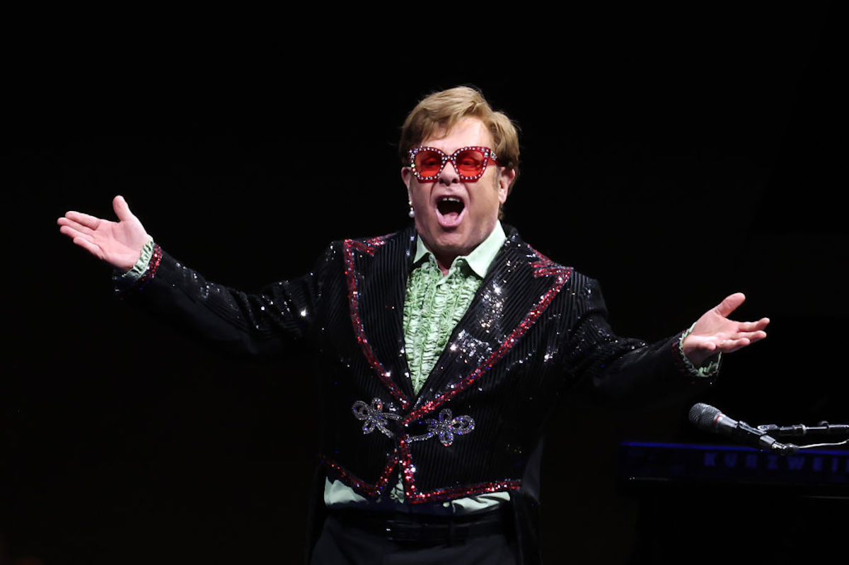 Sir Elton John Performs live on stage in a sparkly tuxedo.