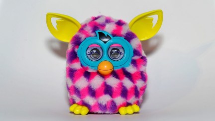 A colorful Furby against a blank white background.