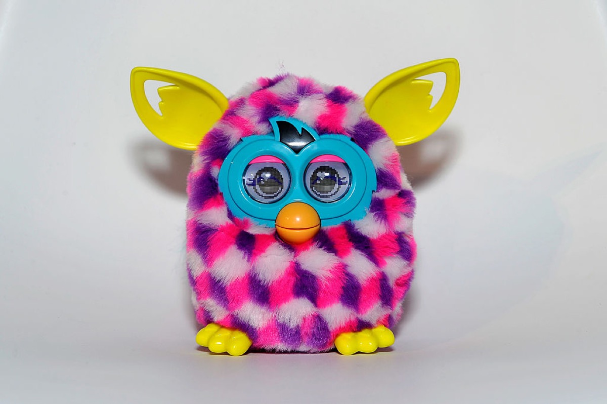 A colorful Furby against a blank white background.