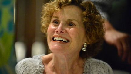 Judy Blume smiles up at someone off camera.