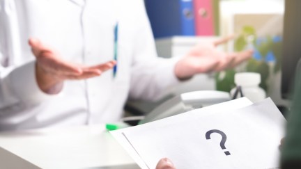 Patient reading health care document with only giant question mark. Clueless doctor spreading hands.