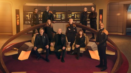 The original cast of Star Trek: The Next Generation, along with Raffaella, Seven, and Jack, pose on the bridge of the Enterprise.